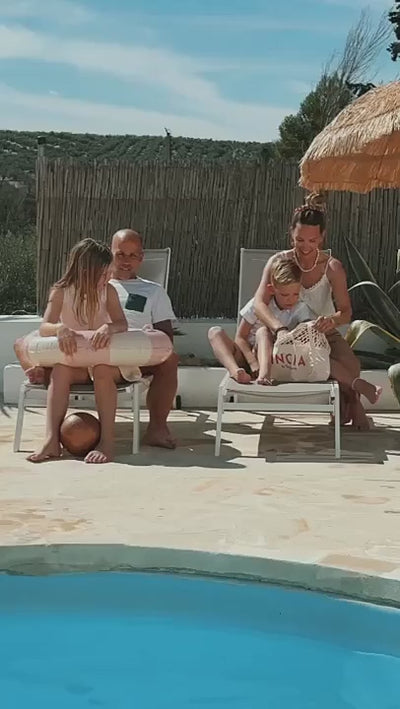 Applying INCIA Natural Sunscreen Lotion for All Family by the pool